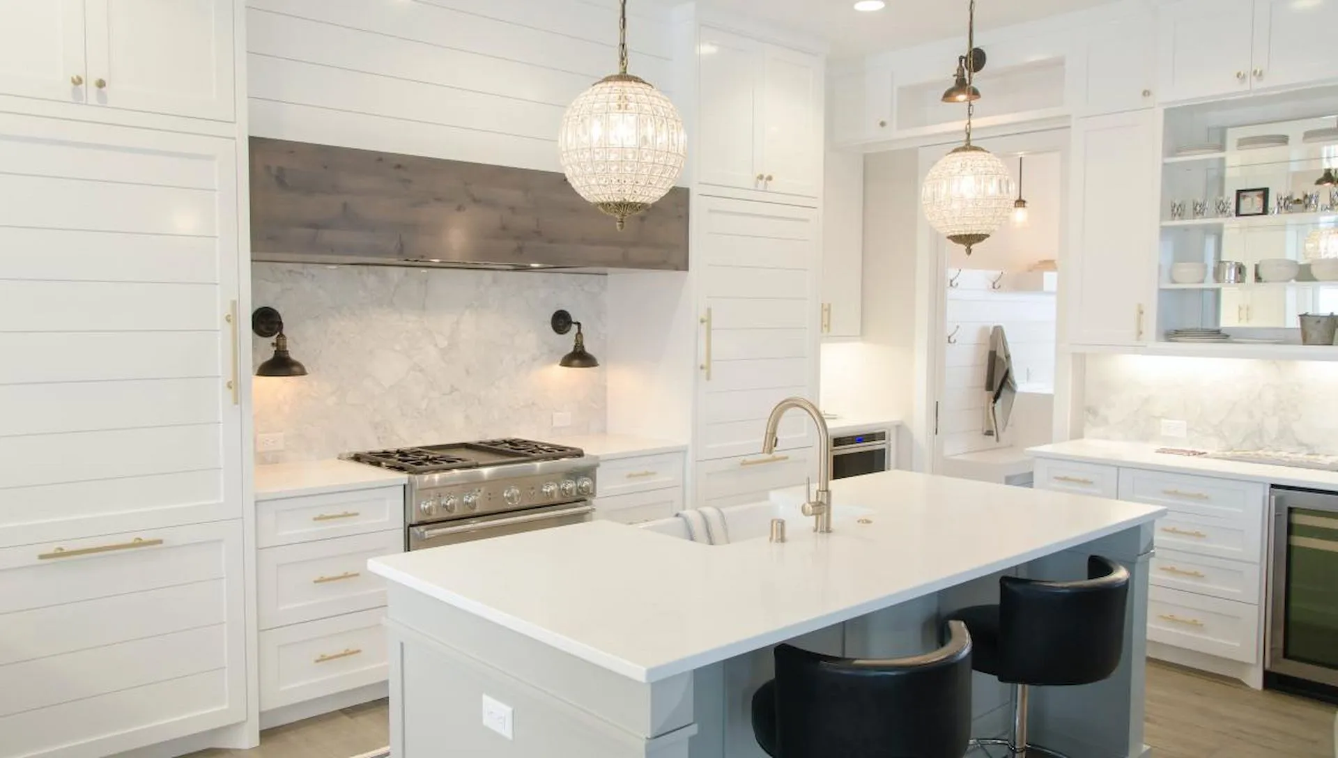 A Kitchen With White Cabinets, Stainless Steel Appliances, and a Large Island — Ozi Construction Pty Ltd in Balmain, NSW