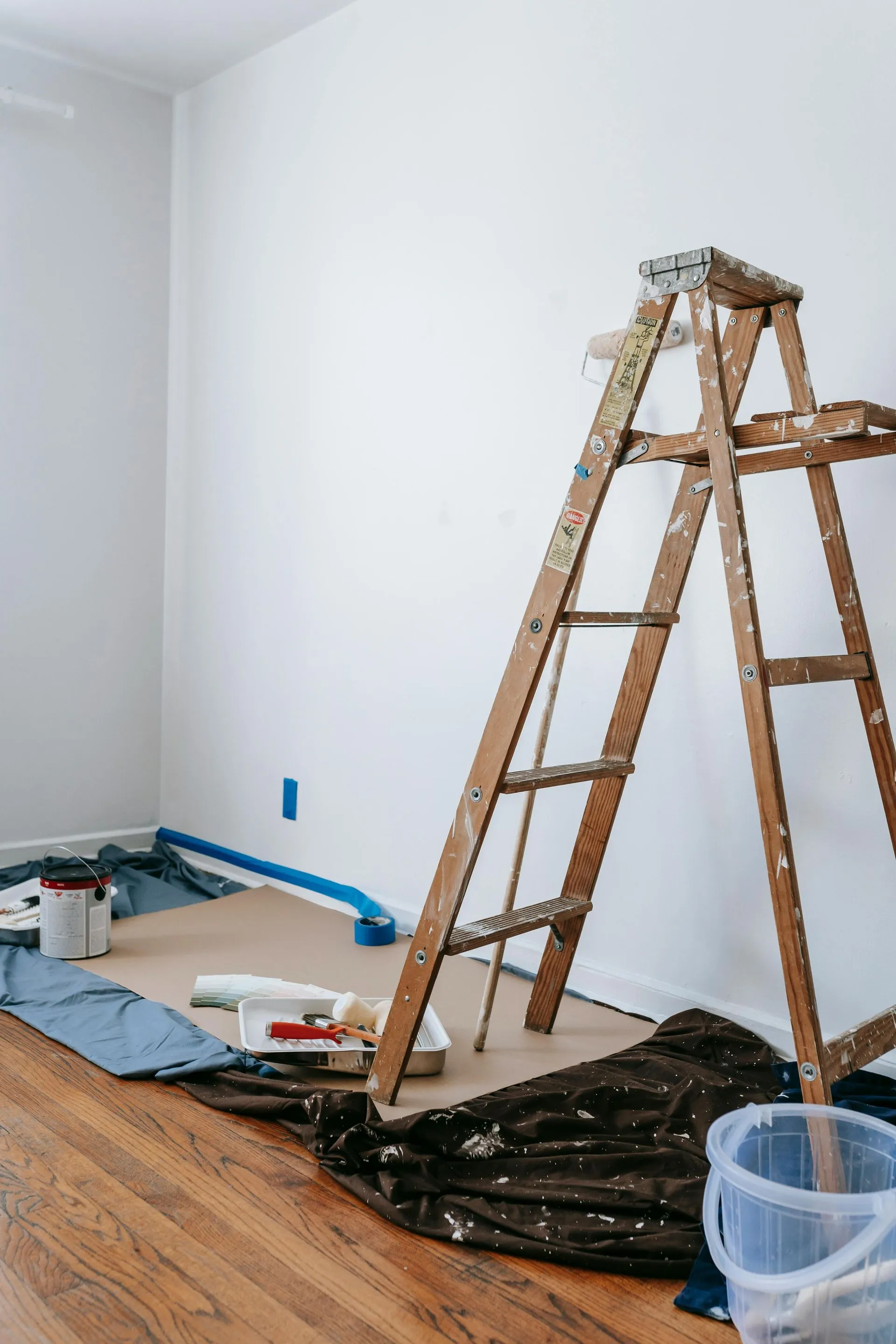 A wooden ladder is sitting on the floor in a room — Ozi Construction Pty Ltd in Balmain, NSW