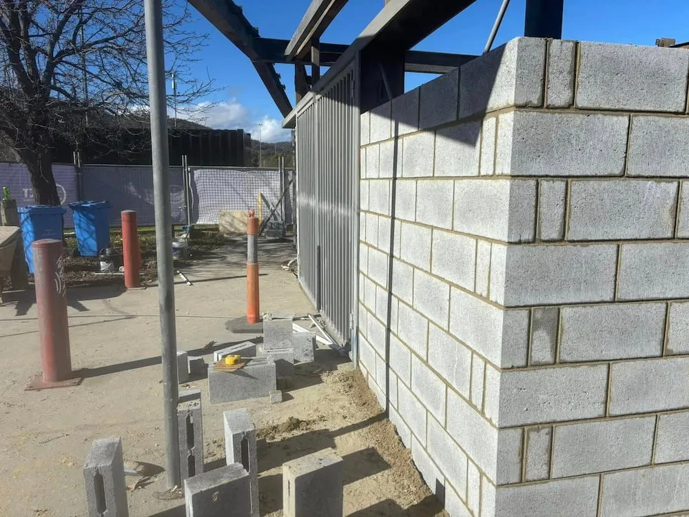 A Brick Wall is Being Built on a Construction Site — Ozi Construction Pty Ltd in Chatswood, NSW
