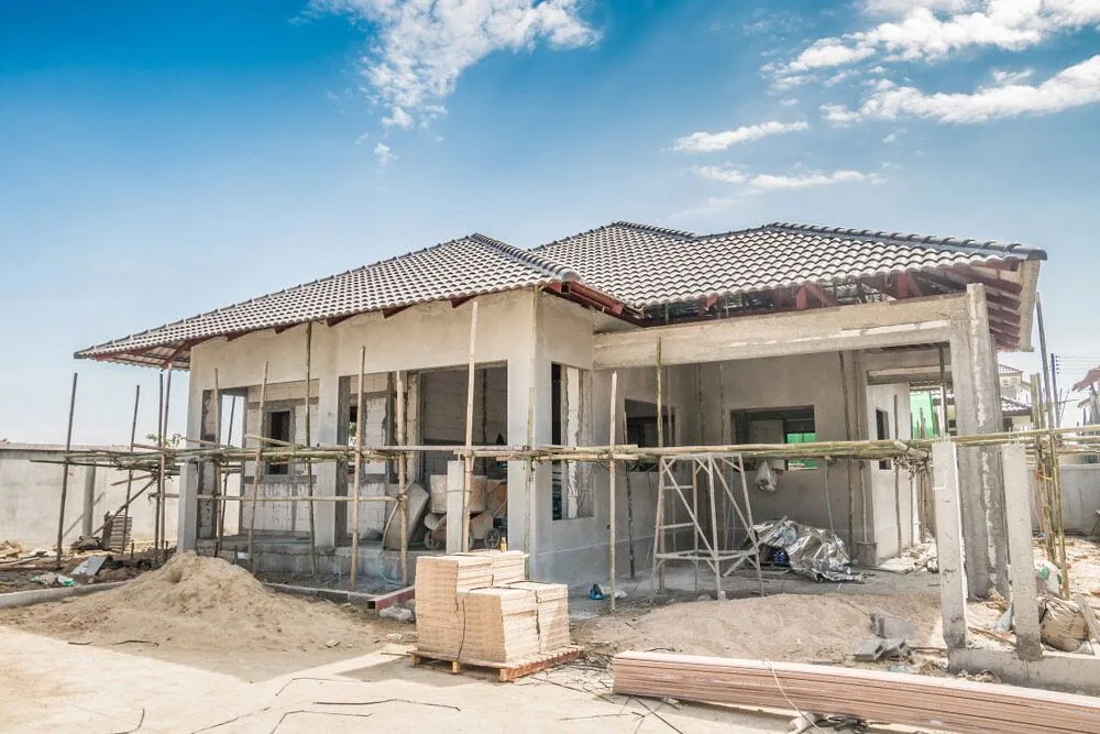 A House is Being Built in the Middle of a Dirt Field — Ozi Construction Pty Ltd in Chatswood, NSW