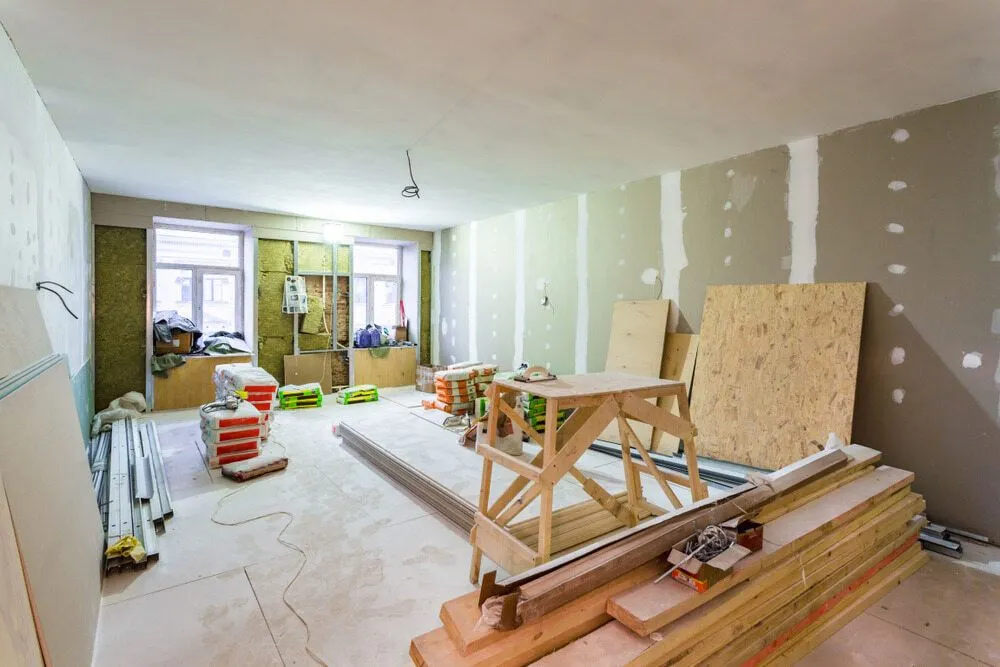 A Room Under Construction With a Lot of Wood and Tools — Ozi Construction Pty Ltd in North Sydney, NSW